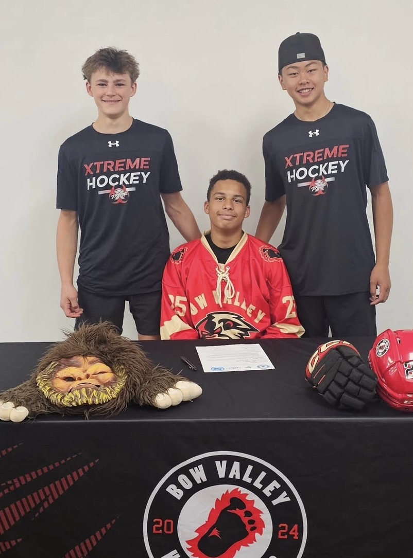 U15 Bow Valley Yeti player signing with the program